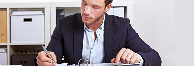 Accounting Technician working at a desk.