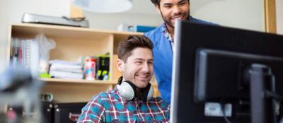 Two people in an office, coding.