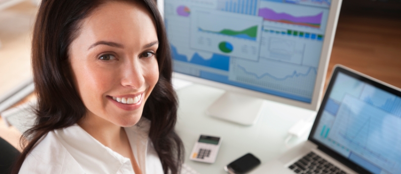 Woman working at her desk taking courses online.