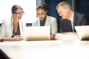 A medical team hears presentation from a health information management specialist, possibly a graduate of the Center for Distance Education