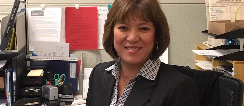 A woman wearing a suit smiling at the camera